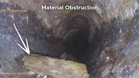 Sewer camera inspection showing a foreign object obstruction inside a sewer line in Plano and Richardson, Texas discovered by The Sewer Inspection Company during a Master Plumber sewer inspection.